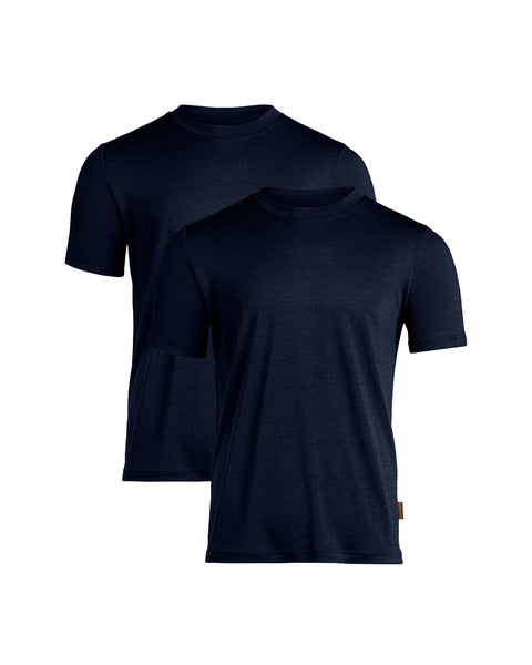 A flat-lay product shot of two men's short-sleeved, crew-neck t-shirts in a dark navy blue color. The shirts have a regular fit and a slightly heathered texture. They are displayed staggered, with one slightly behind and above the other, against a pure white background. The front shirt features a small brown tag on its lower left hem.