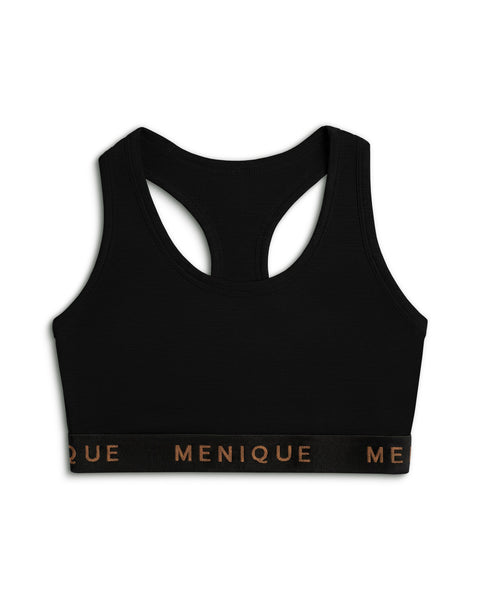 A product shot of a black racerback sports bra laid flat against a plain white background. The bra features a wide black elastic underbust band with the brand name "MENIQUE" printed across the front in bronze lettering.