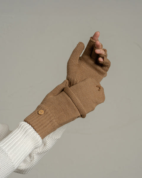 Close-up of caramel brown merino wool convertible gloves highlighting knit texture, ribbed cuffs, and mitten flap.