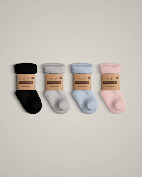 The menique kids' merino wool sherpa lined socks in all available colors, with packaging.