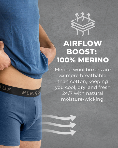 Close-up of man wearing blue Menique merino wool boxer shorts with text ‘Airflow boost: 100% Merino,’ highlighting breathability and natural moisture-wicking.