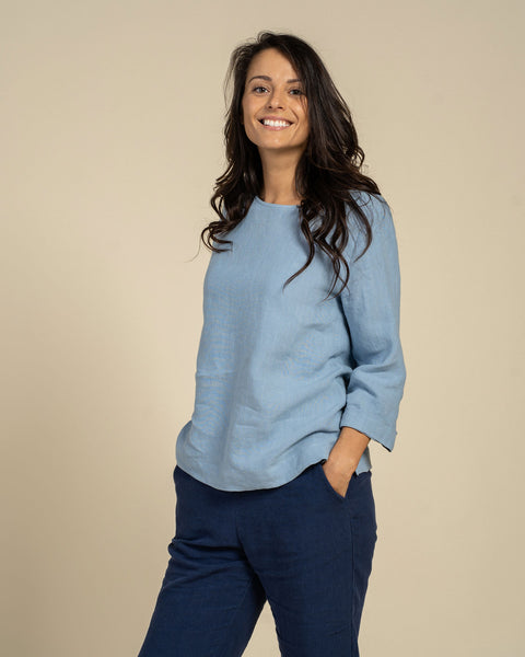 Woman wearing linen blouse in cloudy blue color front