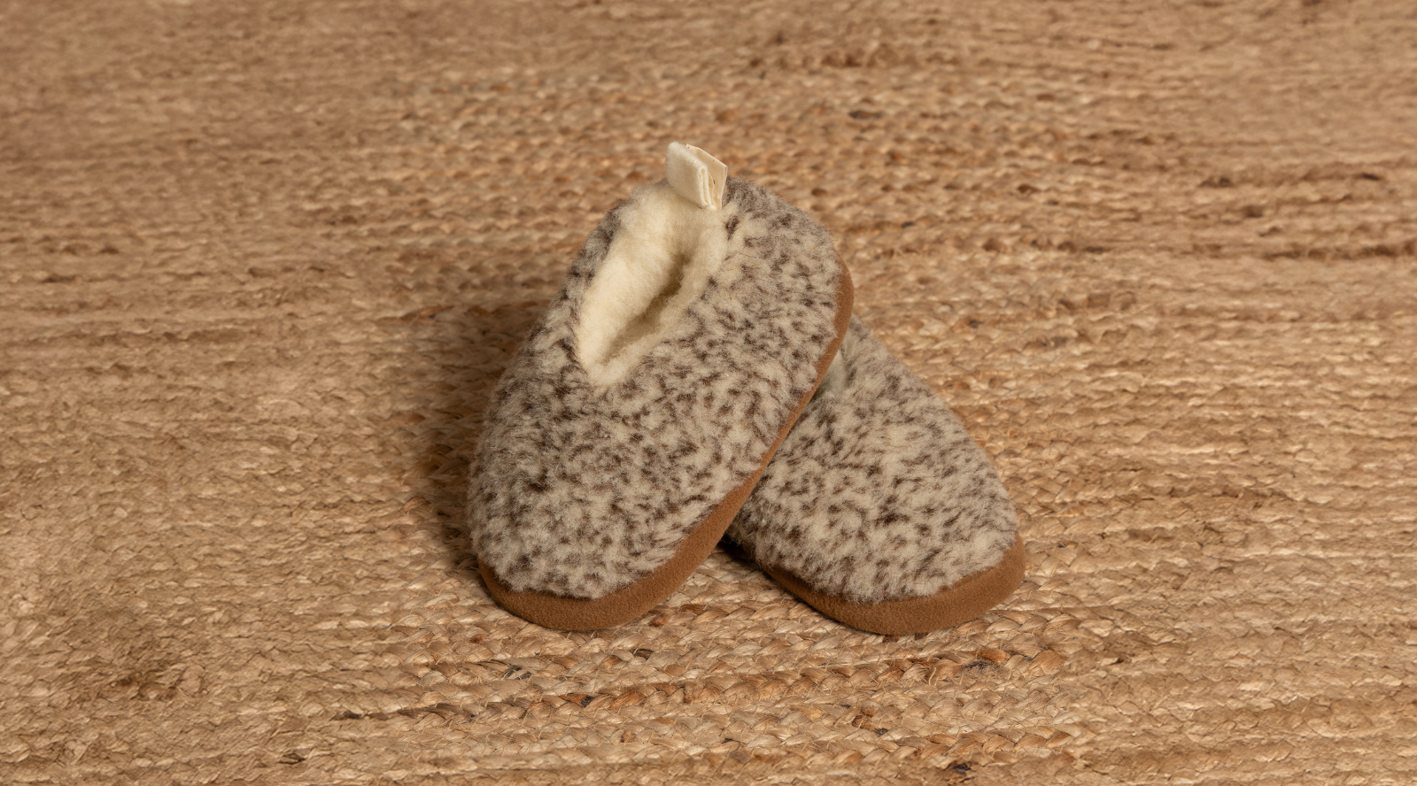 a child wearing dark gray bootie slipper from merino wool.