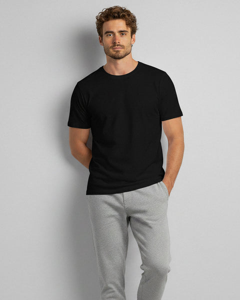 Man wearing a black bamboo t-shirt and gray pants, standing in a relaxed pose.
