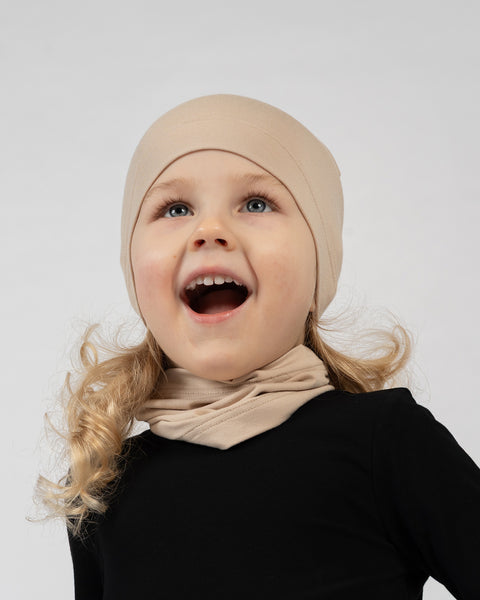Kids bamboo beanie and neck gaiter set in beige, breathable and comfortable layering pieces.