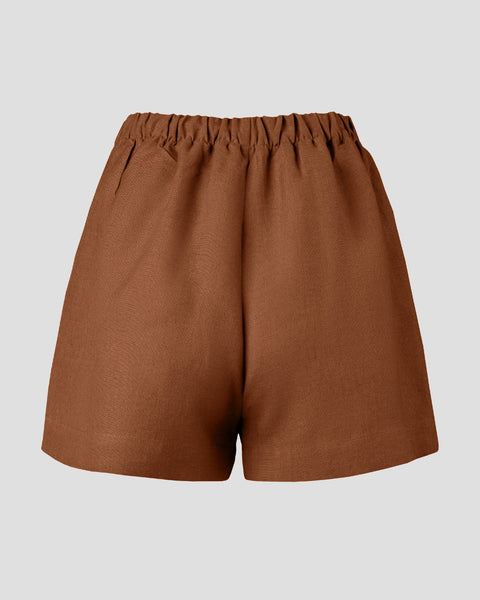 Pull-on linen shorts in the color almond brown.