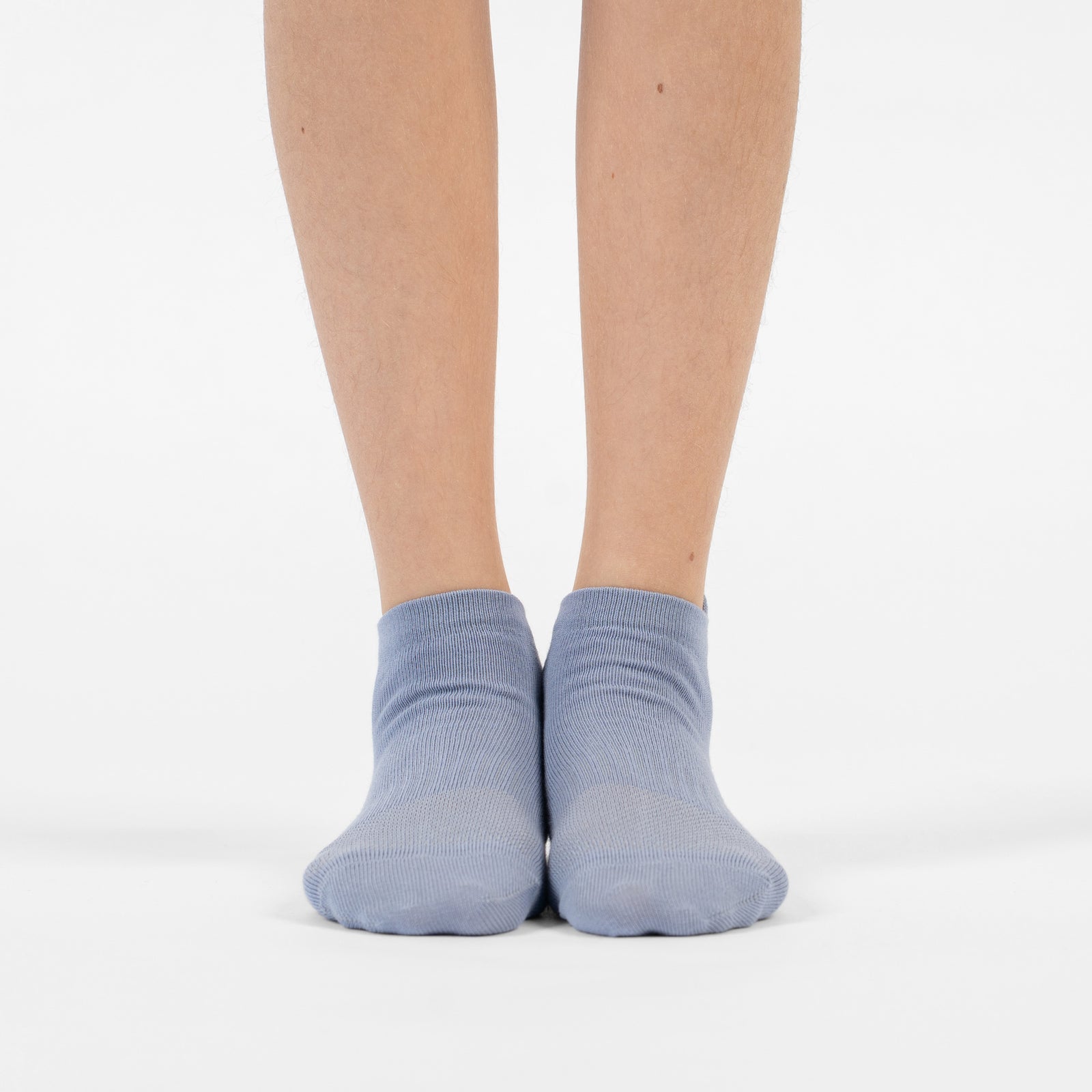 A six-pack of light blue kids' ankle socks arranged in a diagonal row against a white background.