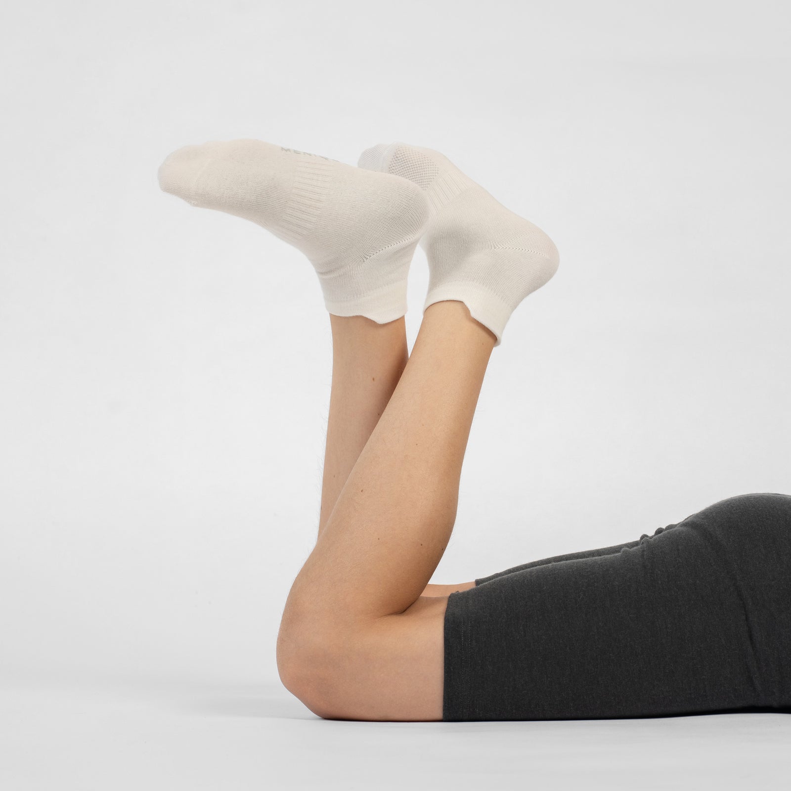 A three-pack of white kids' ankle socks arranged in a diagonal row against a white background.