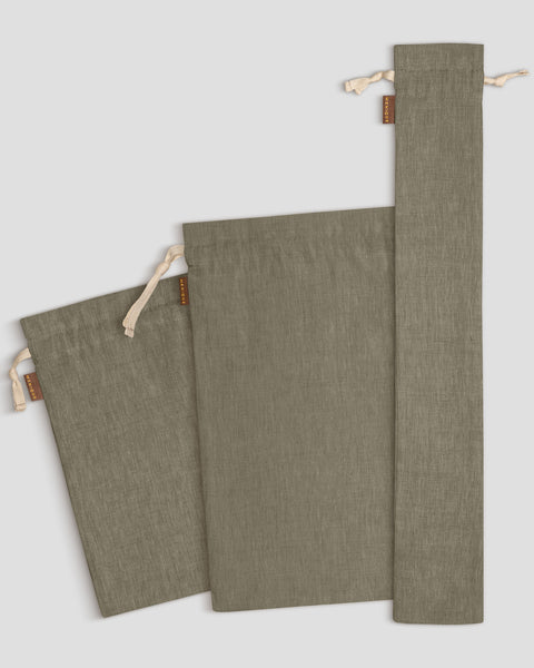 Three stone green drawstring bags on a light gray background