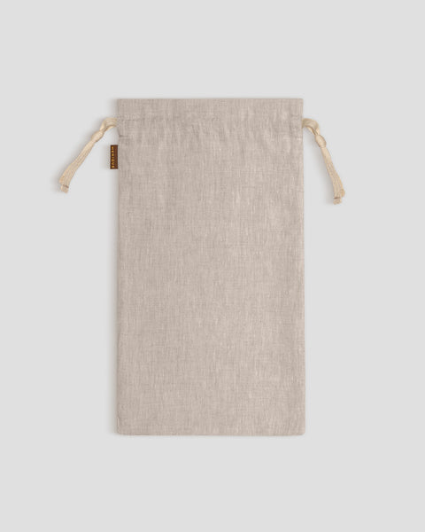 Natural linen drawstring bag on a light gray background