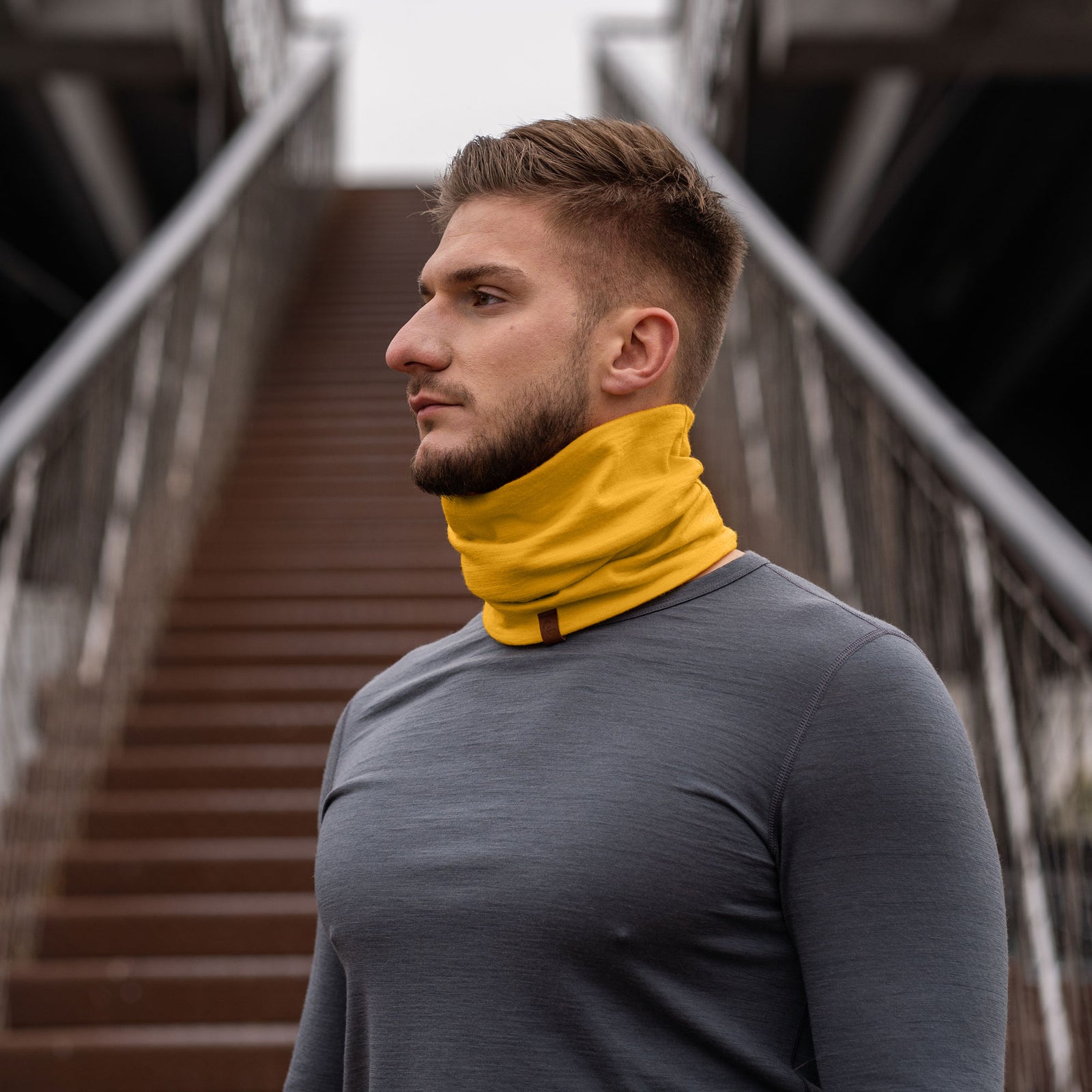 A detailed close-up product shot of the Menique Unisex Spicy Yellow Neck Gaiter, highlighting its vibrant yellow color and soft, breathable fabric. The gaiter's seamless design and stretchy material are emphasized, showing how it can comfortably fit various head and neck sizes. 