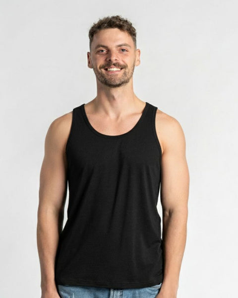 Man wearing a black tank top against a plain background