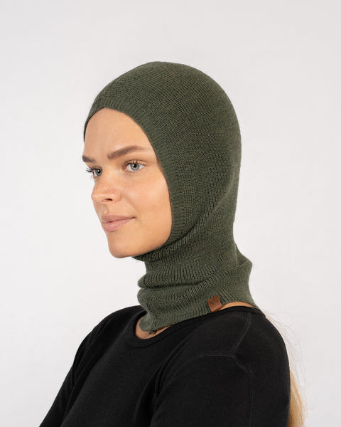 Side profile of woman in dark green knitted Merino wool balaclava with full coverage.