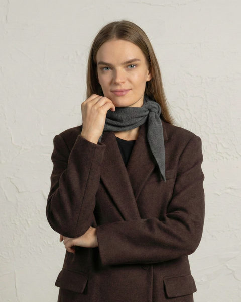 Woman styling a gray cashmere merino knit bandana scarf as a neck accessory