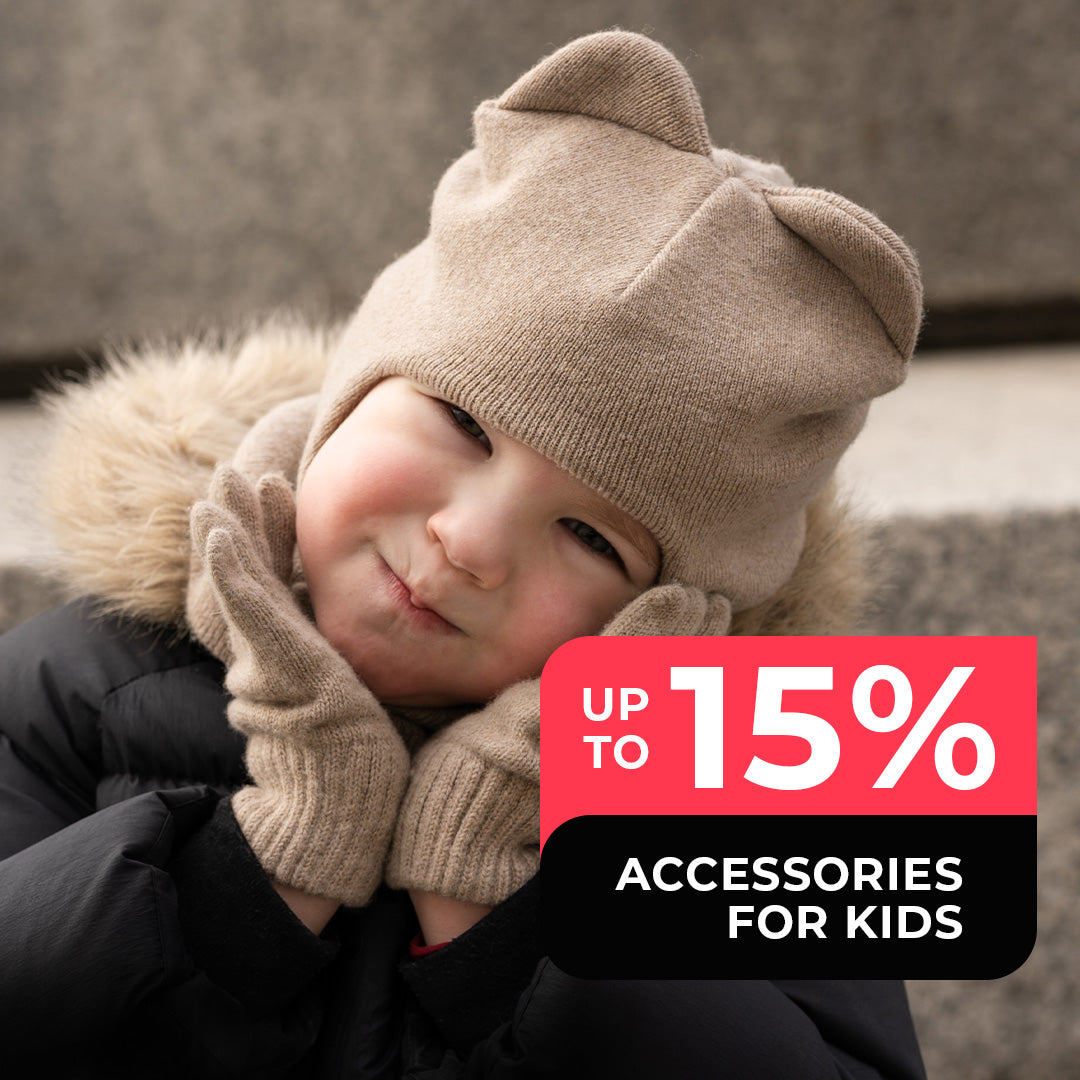 Small girl wearing cute Merino wool balaclava with ears and gloves in creamy beige color. Accessories for kids up to 15% of on black friday sale.