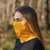 menique unisex neck gaiter in mango power (yellow) color, in a white background.